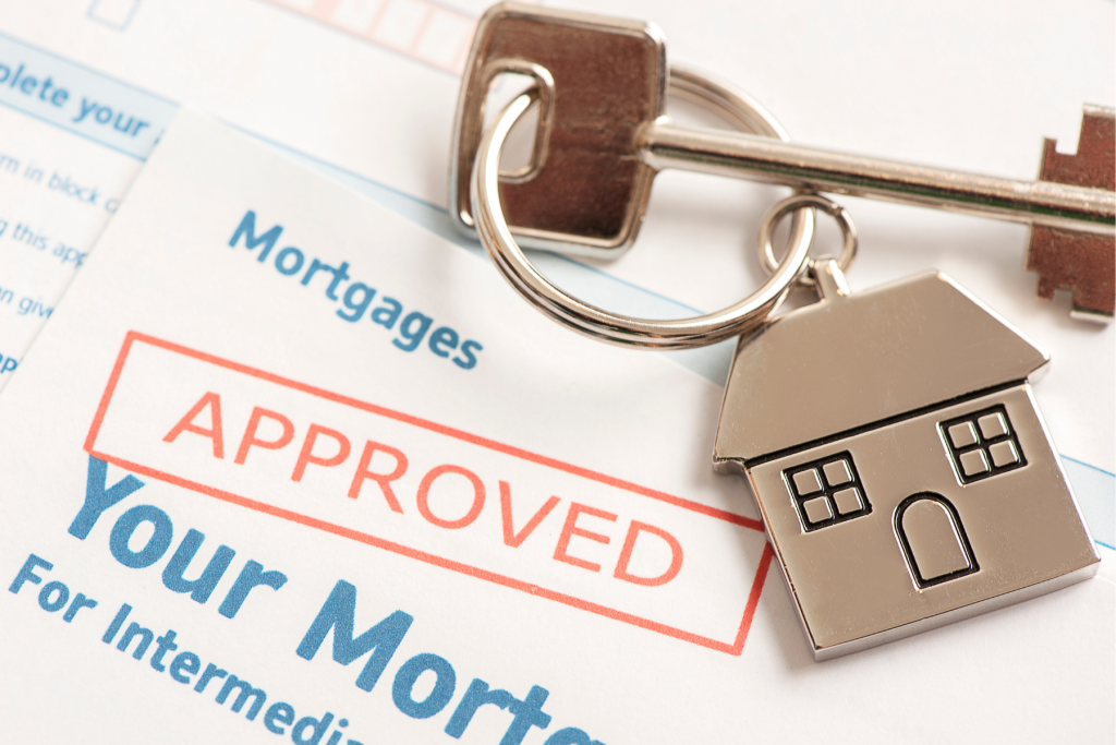 Documents of approved mortgage with the key to the new investment property